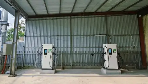 Two DC fast chargers under a canopy at a charging station in Rach Gia